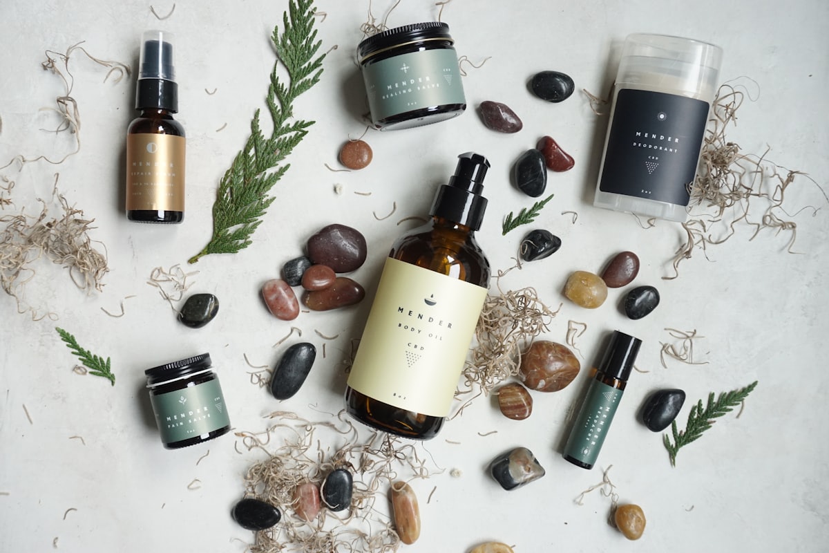 Halden apothecary bottles laid out with river stones and cedar